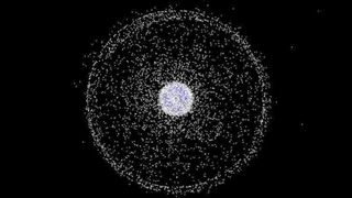 Earth surrounded by white dots that represent space junk