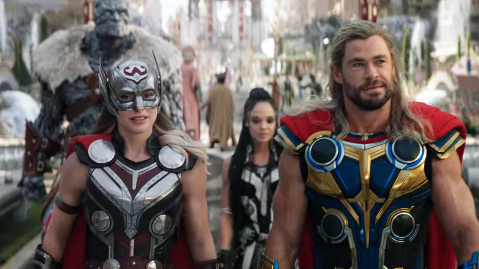 Thor: Love and Thunder, Natalie Portman as Jane Foster (left), Chris Hemsworth as Thor (right) and Tessa Thompson as Valkyrie and Korg in the background