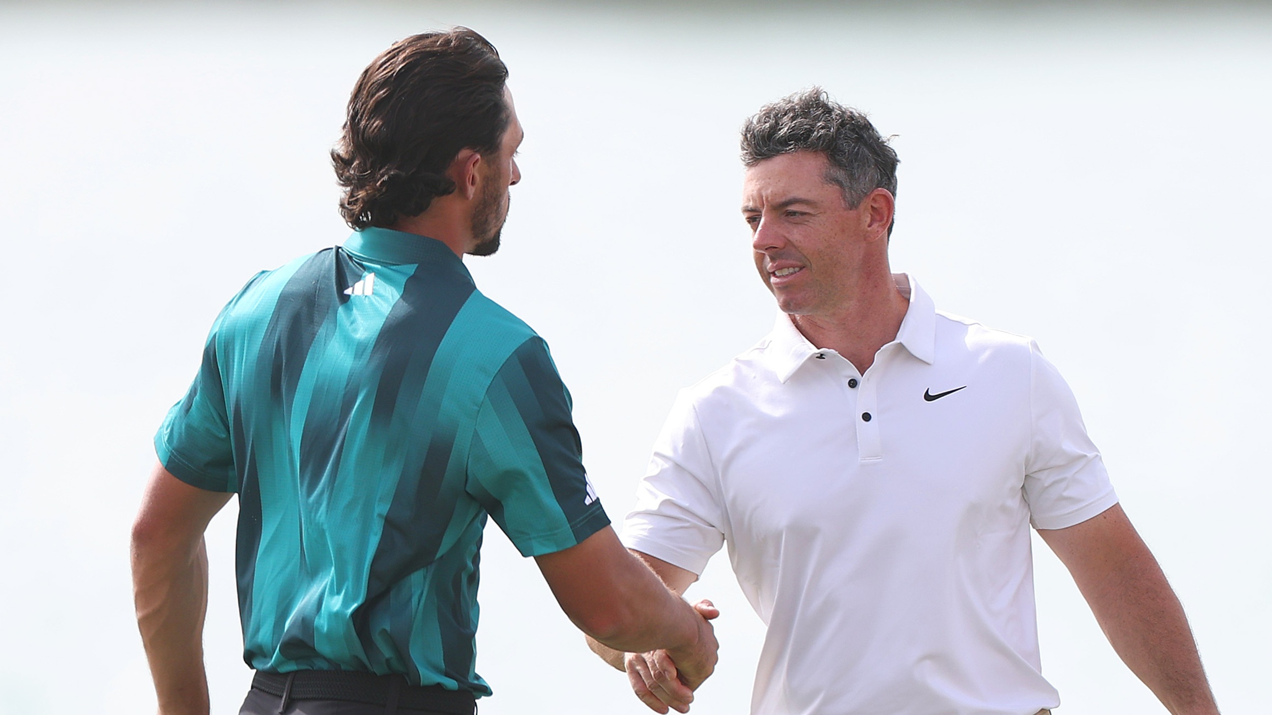Marco Penge and Rory McIlroy shake hands at the Abu Dhabi HSBC Championship