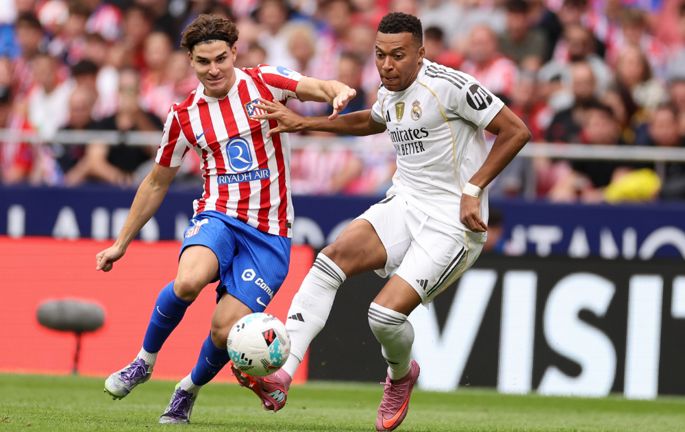 Kylian Mbappe of Real Madrid completes for the ball with Julian Alvarez of Atletico Madrid during the LaLiga EA Sports match between Atletico de Madrid and Real Madrid CF