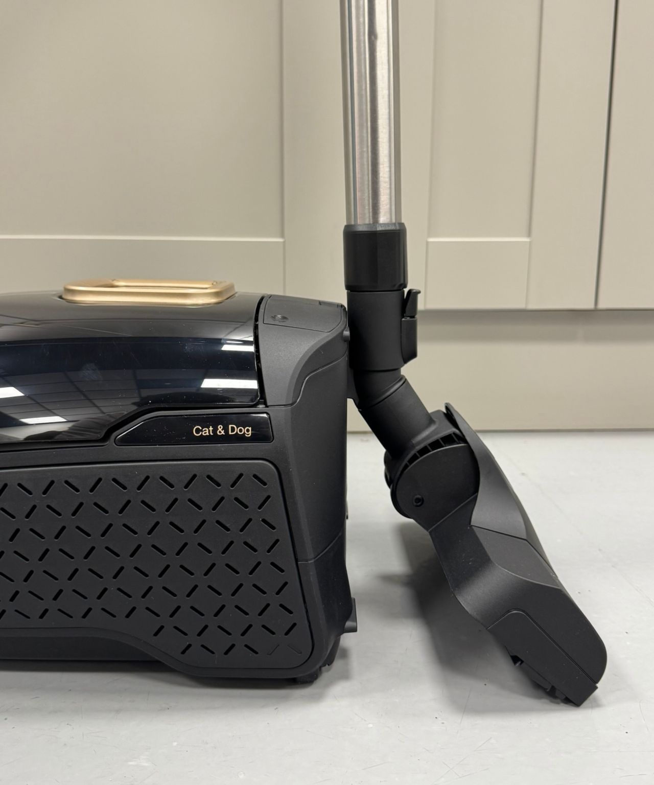Closeup of the Miele Guard L1 Cat and Dog canister vacuum with the floorhead parked in the canister.