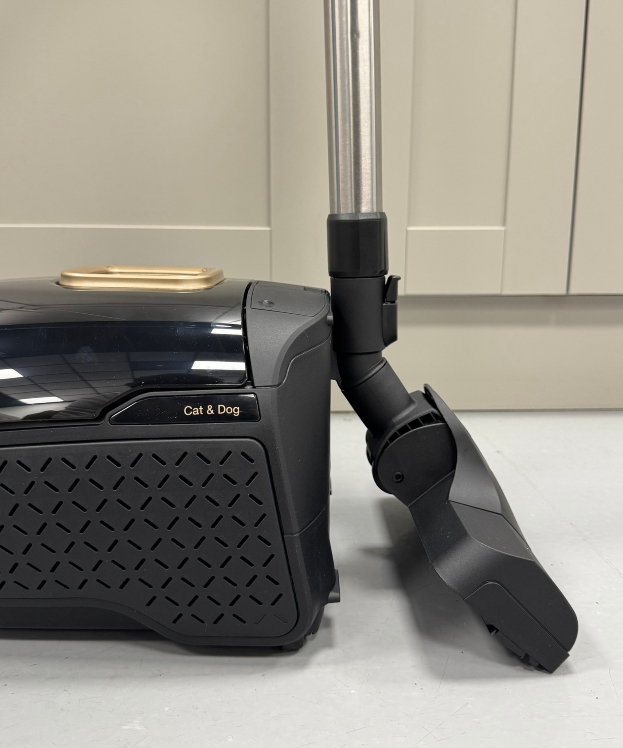 Closeup of the Miele Guard L1 Cat and Dog canister vacuum with the floorhead parked in the canister.