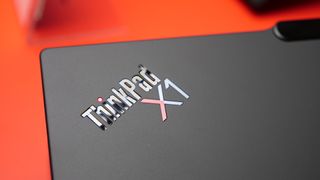 Images of the Lenovo ThinkPad X1 Carbon Gen 13 Aura Edition on a red table at IFA 2024