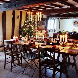 dining area with dining table and chairs and beams and christmas tree