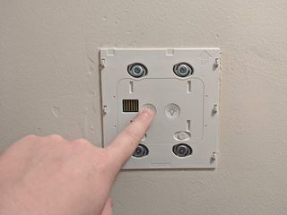 Pressing a button on the Base of the Brilliant Smart Home Panel