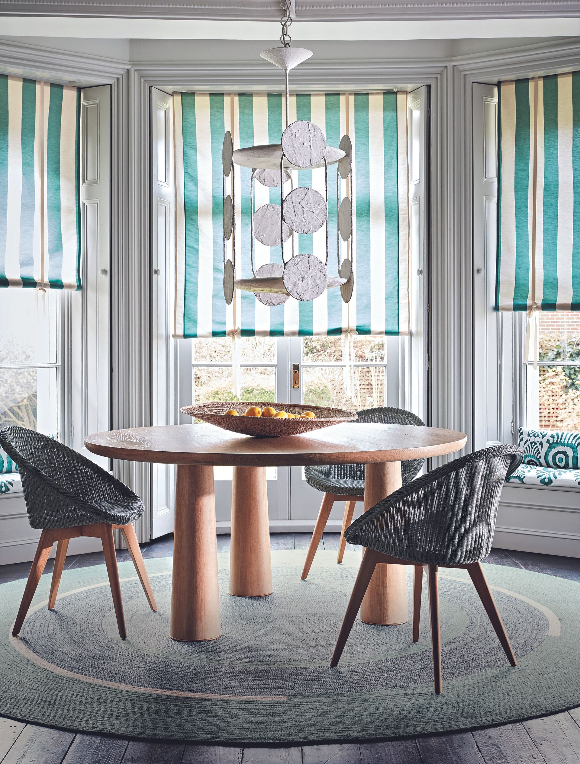 Homes & Gardens Global nomad decorating round dining table and round rug in bay window