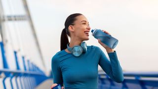 a photo of a healthy woman drinking water