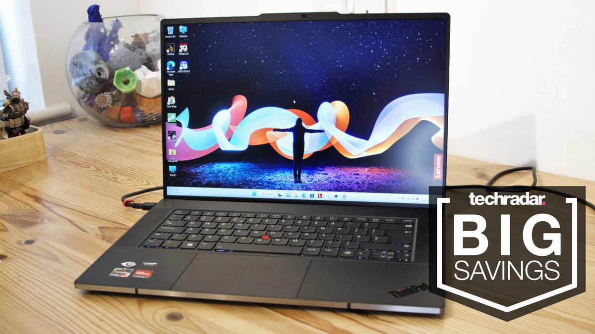 Lenovo ThinkPad on desktop with &#039;big savings&#039; text overlay