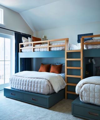 bunk room with space for six in built in bunk beds painted in blue