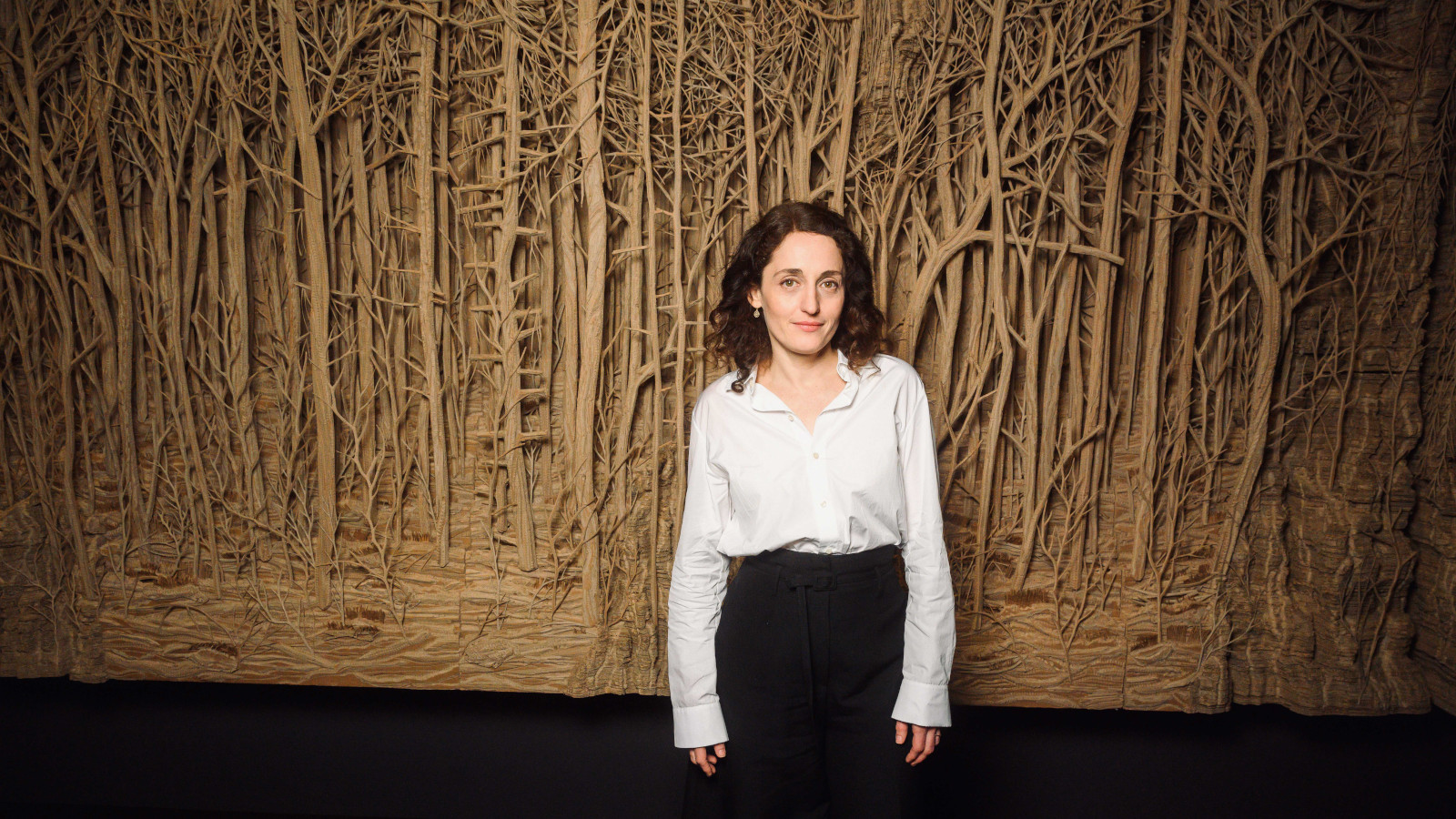 Eva Jospin in front of cardboard installation PROMENADE(S) for Ruinart