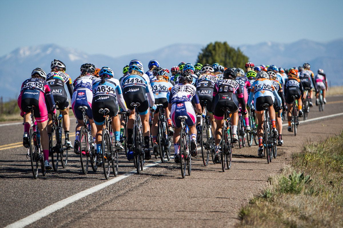 The women head towards the looming mountain top finish