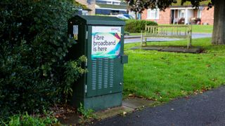 A green telecom cabinet advertising the release of fibre broadband in the area