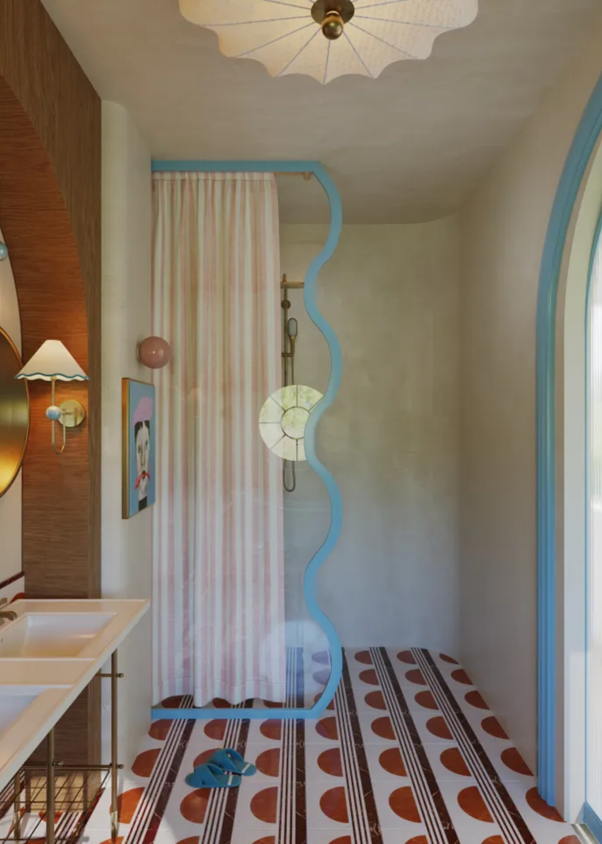 A bathroom with patterned flooring, a bold light above, and a whimsical shower divider in blue