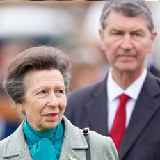 Princess Anne wears a green pussybow shirt with a tweed jacket and husband Sir Timothy Laurence walks behind her