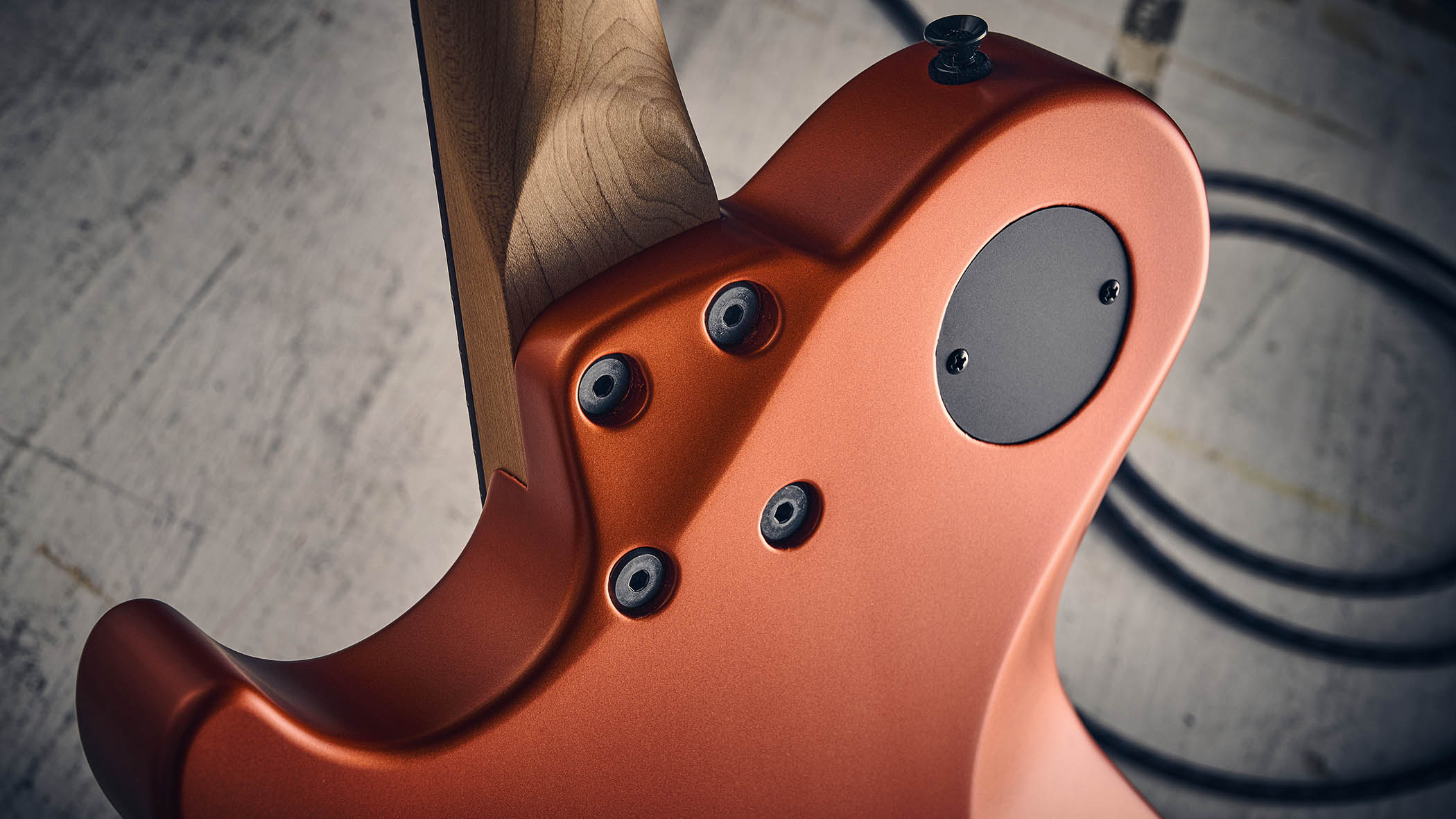 Manson MD-3 Mikey Demus Signature: the hot-orange T-style is photographed against a distressed grey-white background