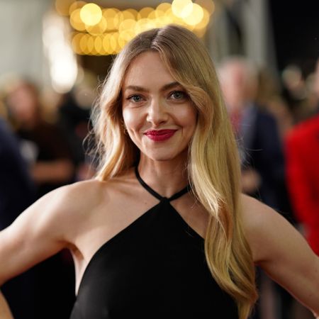 a white woman with blonde hair posing on a red carpet