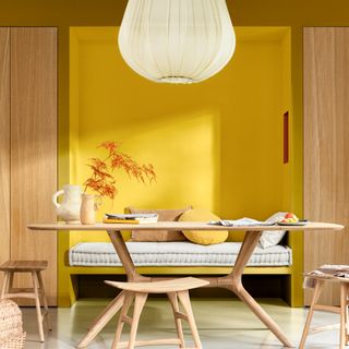 Dulux colour of the year 2025 true joy used in a Scandinavian-style dining room paired with light wood furniture