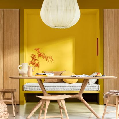 Dulux colour of the year 2025 true joy used in a Scandinavian-style dining room paired with light wood furniture