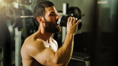 Man drinking weight gainer in the gym