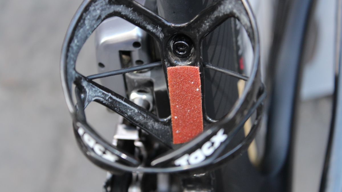 An inside look at Direct Energie's dual bottle-retention fix: grip tape and a rubber band