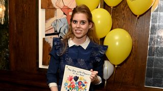 Princess Beatrice poses with Jarvis's winning book 'The Boy With Flowers in His Hair' during the Oscar's Book Prize Winner Announcement