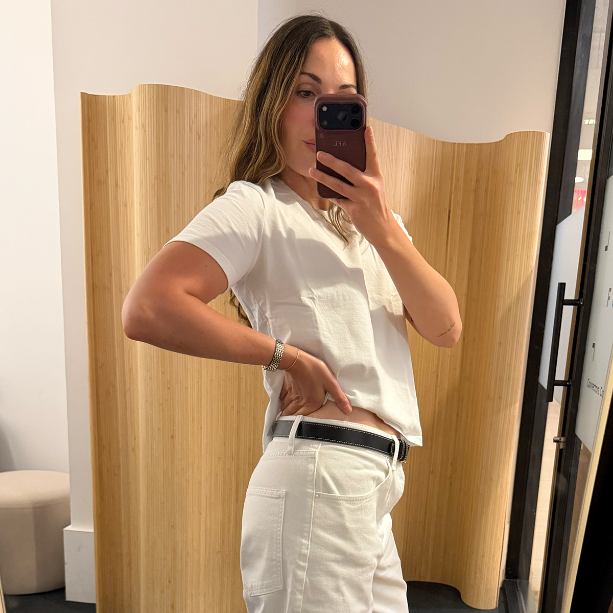 senior fashion editor Anna LaPlaca trying on and reviewing the best white jeans for 2026