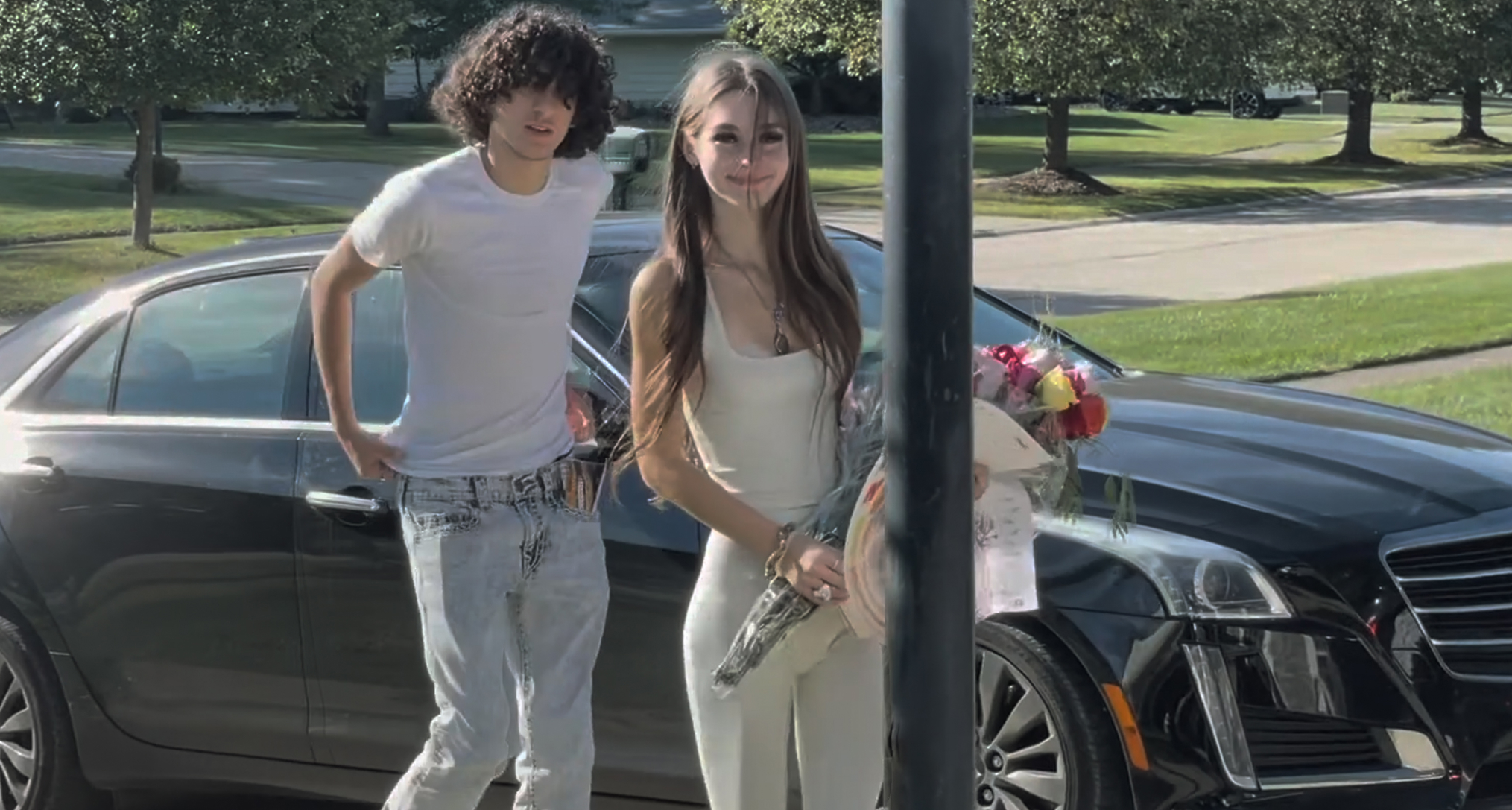 mackenzie Shirilla and Dominic russo posing together as she holds flowers next to her car in a still featured in the documentary the crash