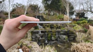 The Oppo Find N5, unfolded, side angle, waterfall in the background