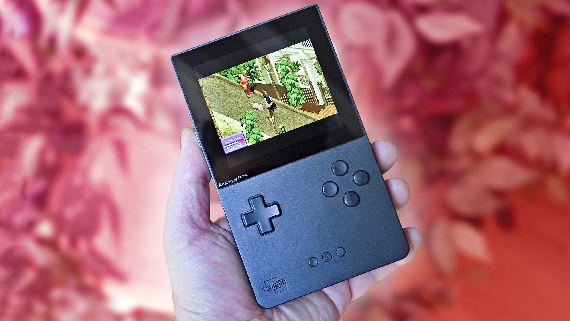 Analogue Pocket in hand with a red background