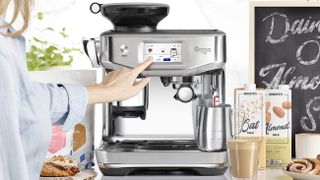 Woman using Sage Barista Touch Impress with Cold Extraction coffee maker