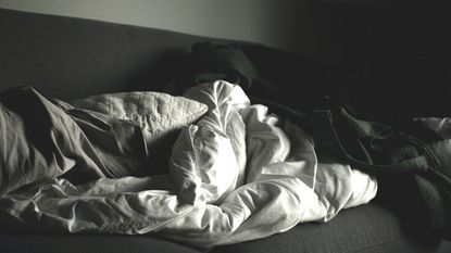 A comforter beside a bedsheet 
