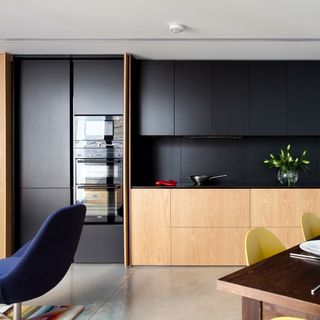kitchen with matte black cabinet and carpet flooring