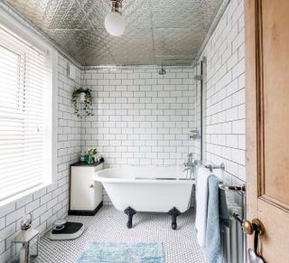 Bathroom with mirrored tile ceiling