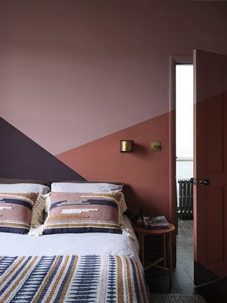 Dark coral bedroom with paint effects created using masking tape