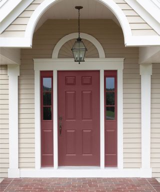 neutral home exterior with dark red front door