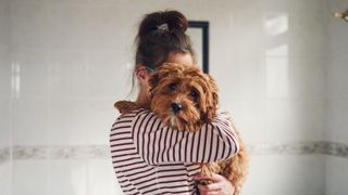 woman holding a dog
