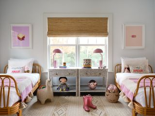 shared kids bedroom with two rattan beds, two bedside tables and separate storage buckets