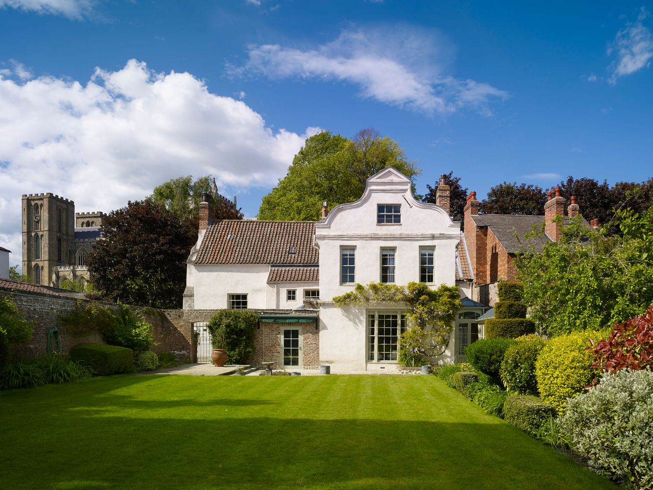 The gabled south range of St Agnes Lodge looks out over the walled garden.