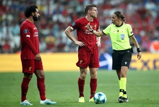Frappart with Liverpool’s Mohamed Salah and James Milner