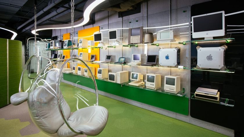 A spinning chair sitting in front of a wall of Apple devices in the MacPaw office