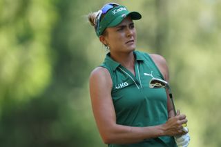 Lexi Thompson watches her iron shot into the green whilst holding an iron