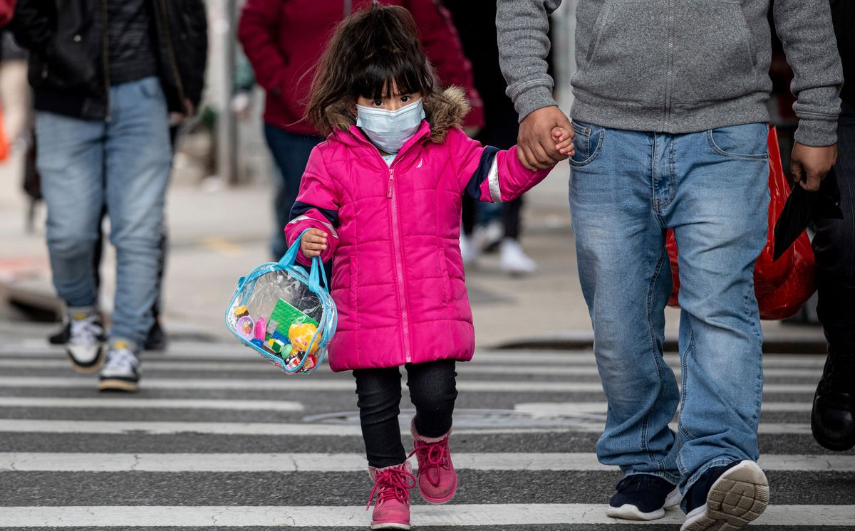 A girl walks down a street in the Corona neighborhood of Queens on April 14, 2020, in New York City.