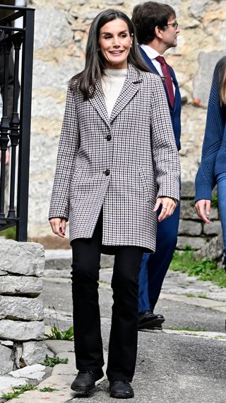 Queen Letizia walks down a hill during her visit to Sotres in October 2024