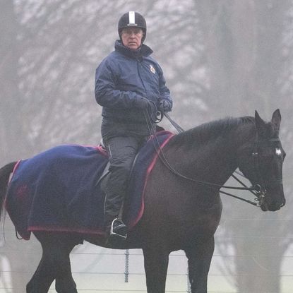 Ex-Prince Andrew rides on his horse during a foggy morning in Windsor