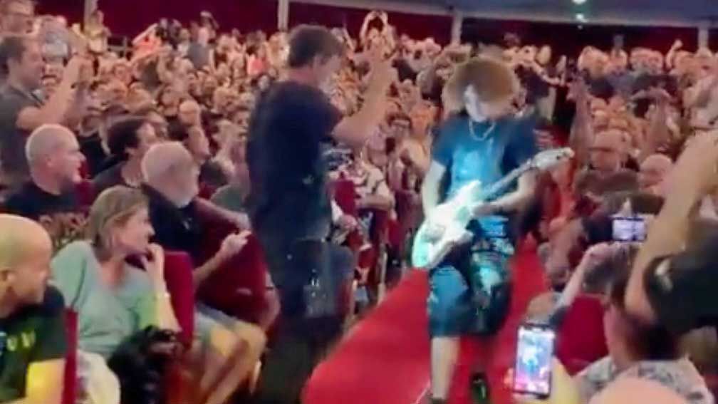 Young guitarist playing Steve Vai&#039;s guitar at a show in Barcelona