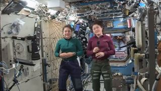 NASA astronauts Jessica Meir and Christina Koch conduct an interview on the International Space Station.