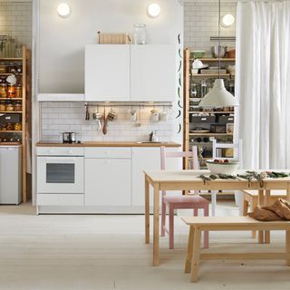 kitchen with kitchen cabinets wooden floooring and wooden table with chairs