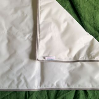 The Silentnight Cooling Gel Pillow Pad on a green linen duvet cover