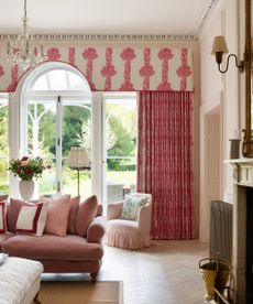 elegant pink living room in georgian home with french doors, curtain pelmet and pink velvet sofas