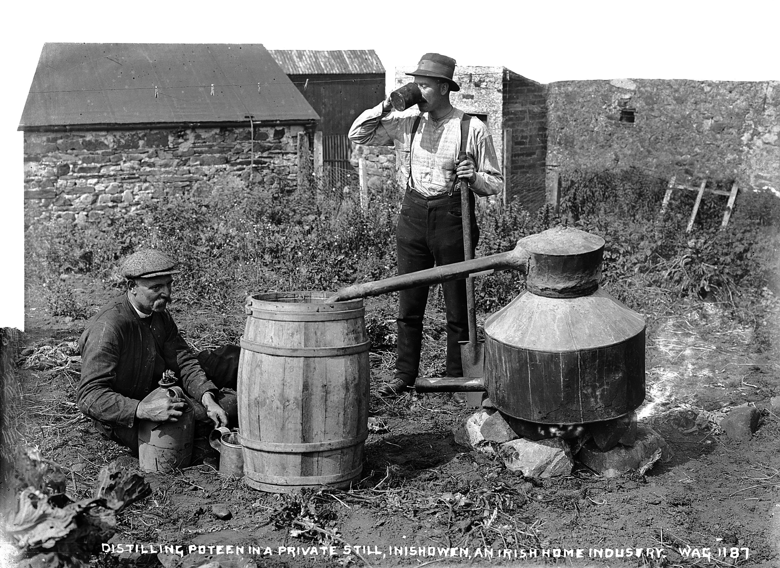 A black and white photo of two men with an illegal Poitin still in rural Ireland